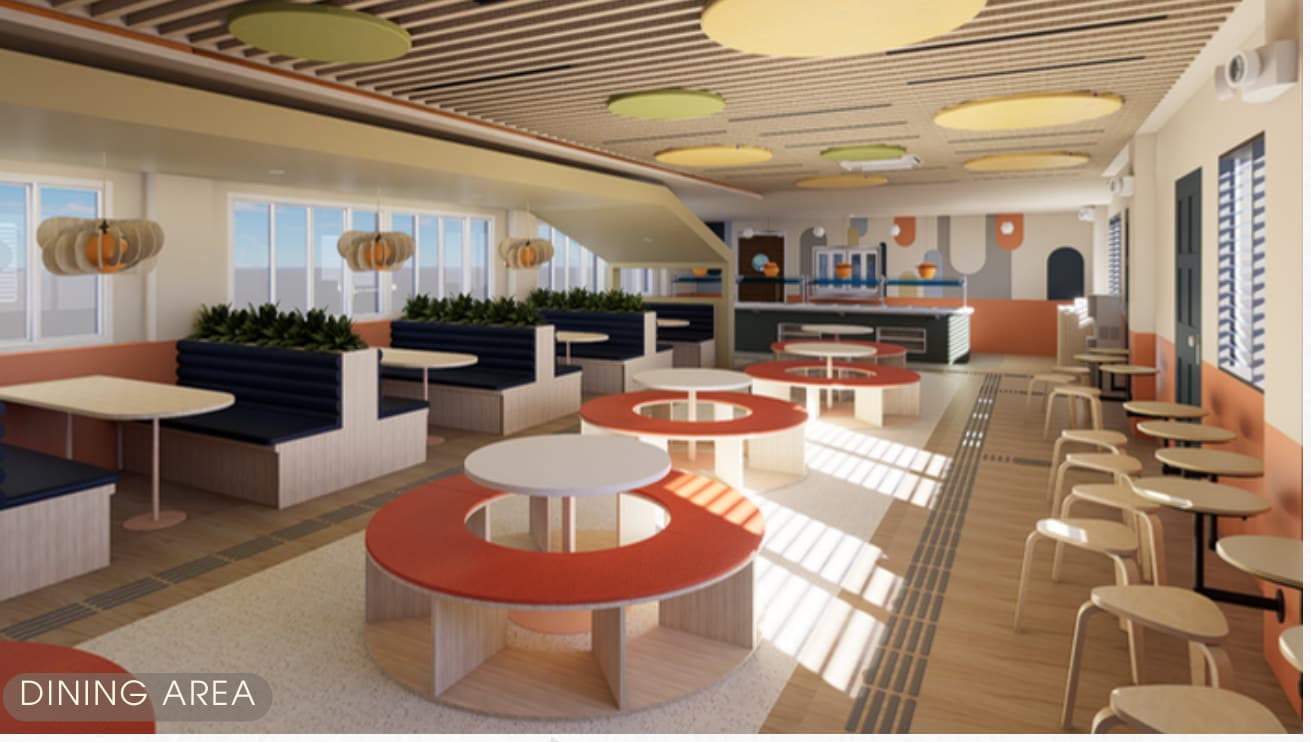School dining hall with circular tables and soft seating
